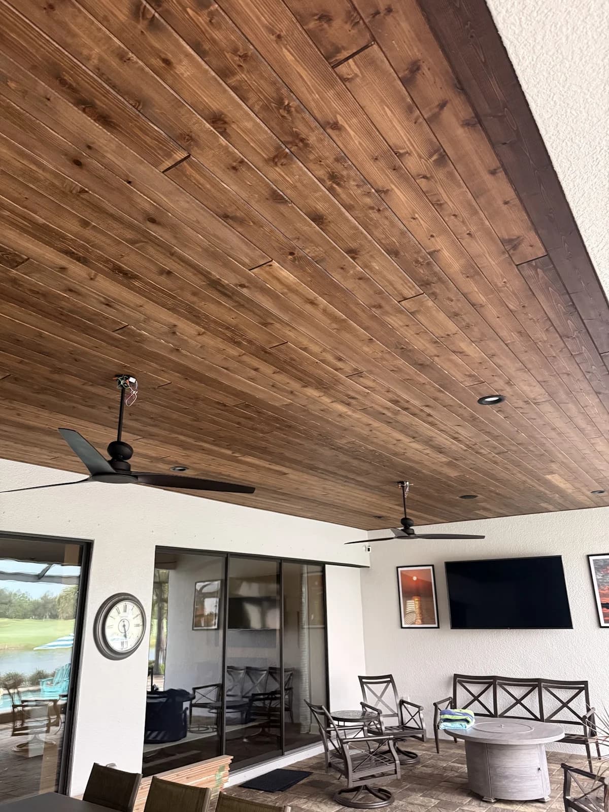 Cedar ceiling boards installed above the lanai seating area and television