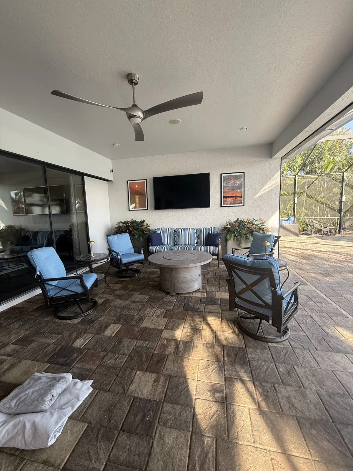 Original drywall ceiling and silver fan above the Esplanade lanai seating area